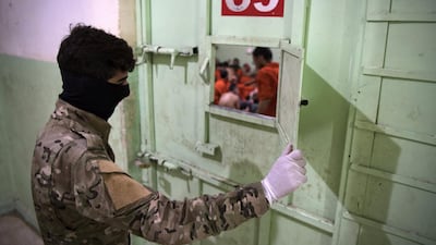 A member of the Syrian Democratic Forces (SDF) stands guard in a prison where men suspected to be affiliated with ISIS are jailed in northeast Syria in the city of Hasakeh on October 26, 2019. AFP