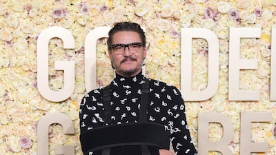 Pedro Pascal, his arm in a sling, wearing Bottega Veneta. AP