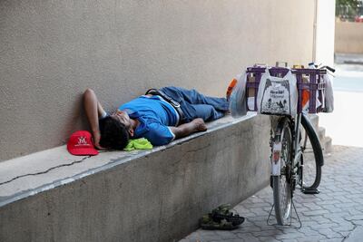 A worker takes a midday break at Bur Dubai. Chris Whiteoak / The National