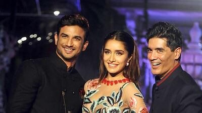 Indian actors Shraddha Kapoor, centre, and Sushant Singh Rajput, left, with Manish Malhotra during Lakmé Fashion Week (LFW) Winter/Festive 2016 in Mumbai on August 24, 2016. AFP / STRINGER
