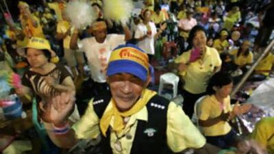 Anti-government demonstrators dance to music outside Government House in Bangkok.