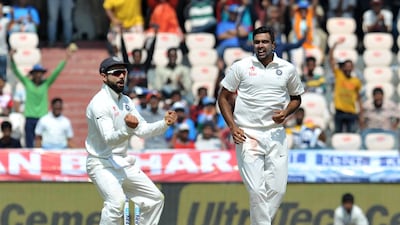 India's Virat Kohli, left, and Ravichandran Ashwin celebrate a wicket against Bangladesh on February 11, 2017. Noah Seelam / AFP
