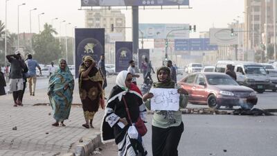 Sudanese protesters carry a placard during a rally in the capital Khartoum to condemn the "massacre" of five demonstrators including four high school students at a rally in a central town of Al-Obeida. AFP