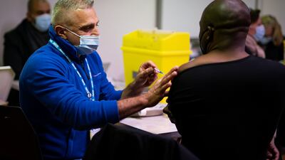 A man receives a Covid booster vaccine at the Abbey vaccination centre in Westminster, London. PA