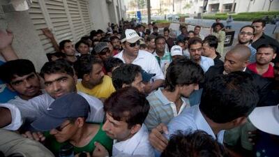 People wait in line to collect a token. Mike Young / The National