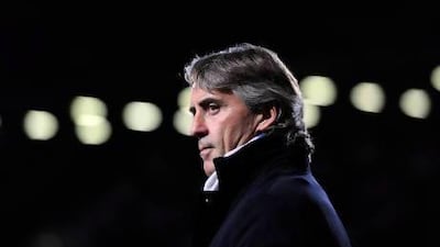 Roberto Mancini can be charming and funny, and is idolised by the Manchester City fans, although, to his players, he can seem a cold figure unafraid to lambast them in public. Glyn Kirk / AFP