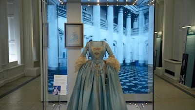 A Georgian-style dress worn by Princess Margaret, the sister of Britain's Queen Elizabeth II, to a charity costume ball in 1964 and created by theatre designer Oliver Messel is displayed in the Royal Style in the Making exhibition at Kensington Palace in London. AP Photo