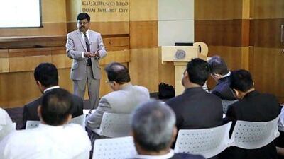 Hari Kesavan, left, shares insights with participants during a discussion on 'demystifying entrepreneurship' in Dubai. (Antonie Robertson / The National)