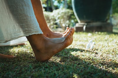 Conscious grounding invites us to walk barefoot across the grass with our eyes closed. Photo: Banyan Tree Phuket