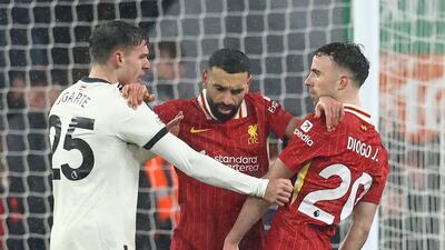 Liverpool's Mohamed Salah, centre, separates teammate Diogo Jota and Manchester United's Manuel Ugarte during a heated match at Anfield that finished 2-2. AFP