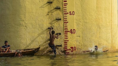 Bangladeshi youths take a bath in the Buriganga River in Dhaka. AFP