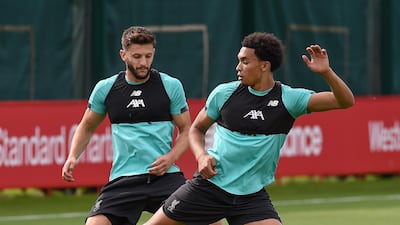 Adam Lallana of Liverpool with Trent Alexander-Arnold during a training session at Melwood on July 24, 2020. Getty Images