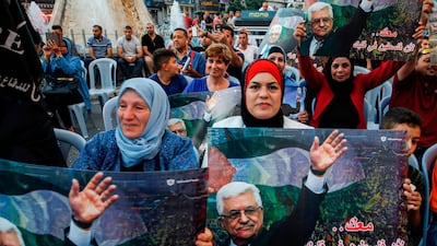 Palestinians chant slogans and wave pictures of Abbas during a demonstration in Ramallah. AFP
