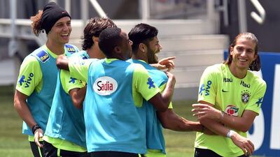 Brazil’s footballers joke with Filipe Luis during a training session. Nelson Almeida / AFP