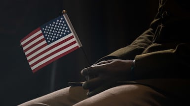 A participant holds an American flag during a naturalisation ceremony in New York. AFP