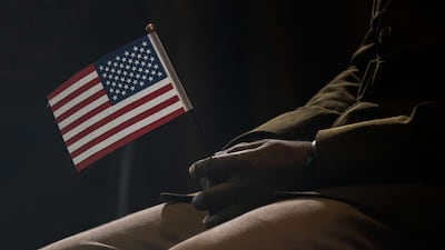 A participant holds an American flag during a naturalisation ceremony in New York. AFP