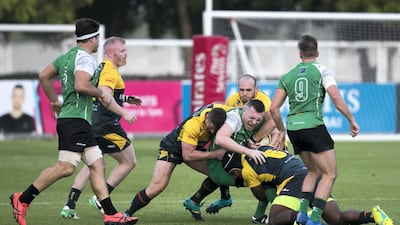 Dubai Hurricanes, in yellow, edged out a 30-28 victory over winless Dubai Sports City Eagles in the West Asia Premiership on Friday. Reem Mohammed / The National
