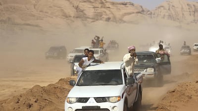 Jordanian Bedouins celebrate as they race camels using robotic jockeys at the Sheikh Zayed track in the town of al-Disi in the desert of Wadi Rum valley, on November 9, 2019