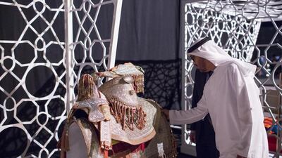 Sheikh Mohammed bin Zayed, Crown Prince of Abu Dhabi and Deputy Supreme Commander of the Armed Forces, looks at an old saddle on display at the Moroccan Heritage Week exhibition. Ryan Carter / Crown Prince Court — Abu Dhabi