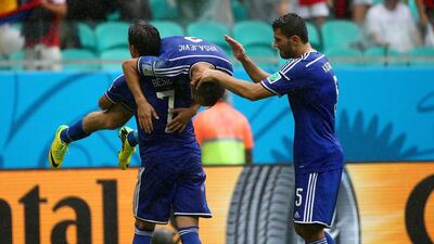 Avdija Vrsajevic of Bosnia, up, celebrates with teammates after scoring his team's third goal on Wednesday against Iran at the 2014 World Cup in Salvador, Brazil. Robert Cianflone / Getty Images