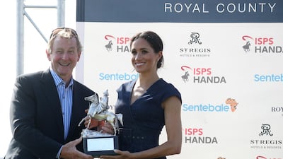 Meghan Duchess of Sussex and Enda Kenny pose with the Sentebale Polo 2018 trophy after the Sentebale Polo 2018 held at the Royal County of Berkshire Polo Club Getty Images
