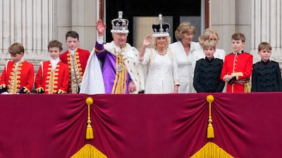 King Charles III and Queen Camilla wave to the crowds from the balcony of Buckingham Palace after their coronation ceremony. AP