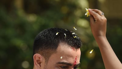 Former Barcelona and Spain midfielder Xavi is welcomed during the ground breaking ceremony of an astro-turf football pitch in Mumbai.