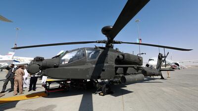 The Boeing AH-64 Apache, four-blade, twin-turboshaft attack helicopter with a tailwheel-type landing gear arrangement and a tandem cockpit for a two-man crew, gets some views from military personnel at the Dubai Airshow. Victor Besa for The National