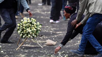 A distraught relative is assisted at the crash site. AFP