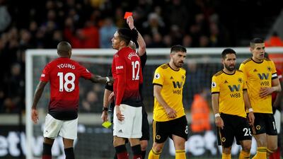 Manchester United's Ashley Young is shown a red card. Reuters