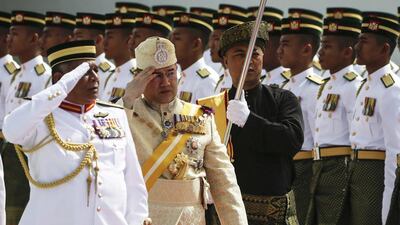 Sultan Muhammad V inspects a guard of honour at Parliament Square, in Kuala Lumpur. Fazry Ismail / EPA