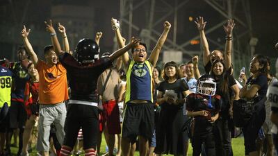 Parents and players from the Vipers American football team cheer after a touchdown during their game in Beijing last month. Mark Schiefelbein / AP