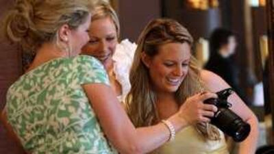 Contestants in Dubai view photographs of themselves during a phase of the International Rose of Tralee Festival held in Dubai.