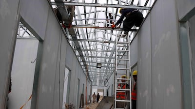 Afghan workers build a makeshift hospital comprising of 100 beds in Herat, Afghanistan. EPA