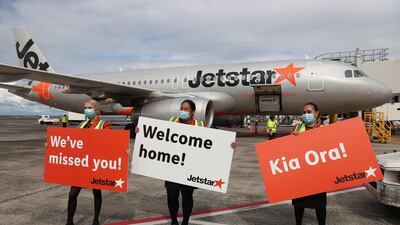 Staff welcome the first quarantine-free trans-Tasman flight to Auckland from Sydney in Auckland, New Zealand. Getty