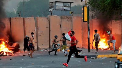 Anti-government protesters set fire in Baghdad. AP Photo