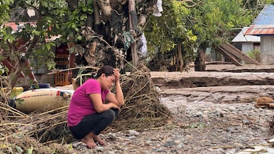 A resident reacts near her flood-hit house in Tuao town, Cagayan province, after Super Typhoon Fung-wong hit the Philippines leaving villages submerged and towns without electricity. AFP