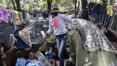 Arelvis Perez, a Venezuelan migrant from Menegrande, Zulia state, who worked as seamstress in a manufacturing company in Bogota for a year, remains at her tent with her grandmother and her daughters Marly and Ashly at en encampment where jobless and homeless migrants are camping during the coronavirus pandemic in Bogota, Colombia. Getty Images