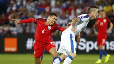 England defender grimaces after a challenge from Slovakia’s Juraj Kucka. Kai Pfaffenbach / Reuters