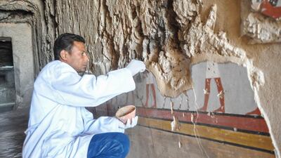 An Egyptian archaeologist works on a newly-discovered tomb of Shedsu-Djehuty at the Draa Abul Naga necropolis in Luxor's West Bank, 700 km south of Cairo, on April 18, 2019. AFP