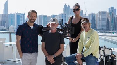 From left, actor Ryan Reynolds, Ian Bryce, producer, actress Adria Arjona, and director Michael Bay pose in front of the Abu Dhabi skyline in one of the first photos from the '6 Underground' shoot. Christian Black - Netflix