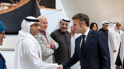 Mr Macron is greeted by Fahad Al Raqbani, UAE ambassador to France, before the lunch meeting