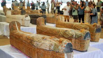 Tourists look at painted ancient coffins at Al-Asasif necropolis, unveiled by Egyptian antiquities officials in the Valley of the Kings in Luxor, Egypt. REUTERS