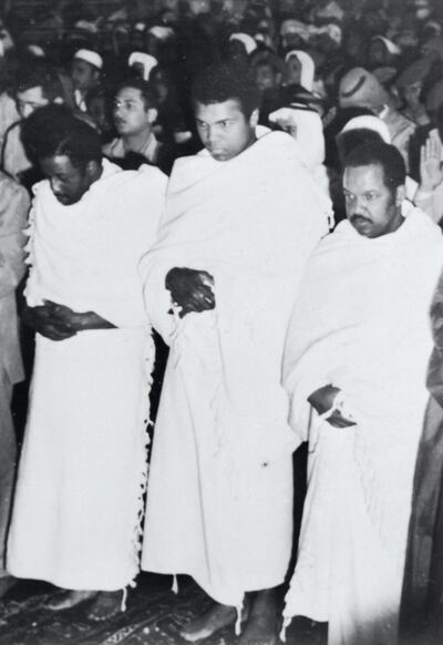 Flanked by fellow pilgrims, Muhammad Ali, three-time heavyweight champion of the world, prays inside the Holy Mosque in Makkah during Hajj in 1972. Bettmann Archive