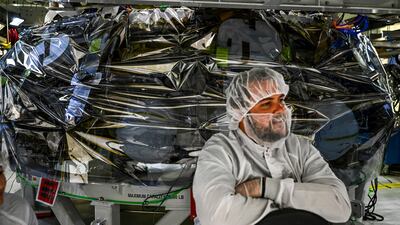 An engineer sits near the Orion capsule for the Artemis II mission at the Kennedy Space Center in Cape Canaveral, Florida. AFP