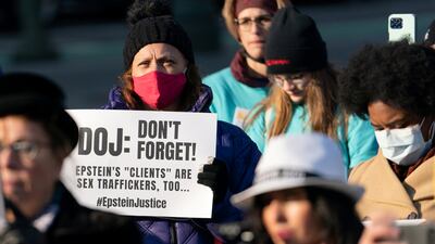 A protester holds a placard during a rally in New York City for Epstein survivors. Reuters