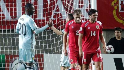 Belgium forward Christian Benteke, left, celebrates with teammate Dries Mertens after scoring the fastest goal in World Cup qualifying history. Jose Manuel Ribeiro / AFP