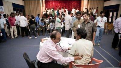 Doctors attending to labourers without medical insurance at a free medical camp organised by the Indian Ladies Association, Dubai at the Indian Consulate Dubai on Friday, February 11, 2011.