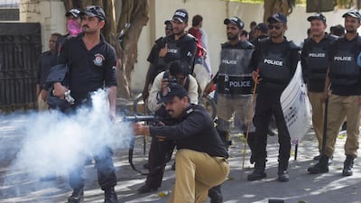 Police in Pakistan's Sindh province fire tear gas during a protest in Karachi on March 28, 2019. AFP