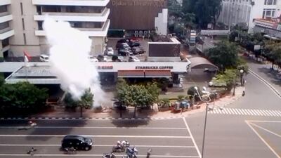 Smoke rises from a bomb blast outside a Starbucks in Jakarta in a still image taken from amateur video shot on January 14, 2016. Amateur video via Reuters TV